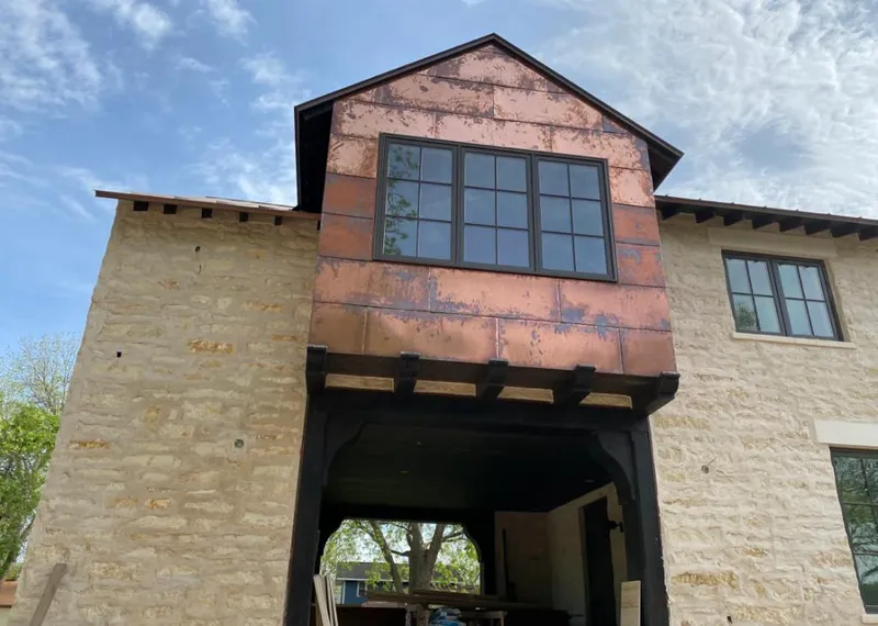 Copper metal panel facade on a stone building for Roof Repair in Nampa